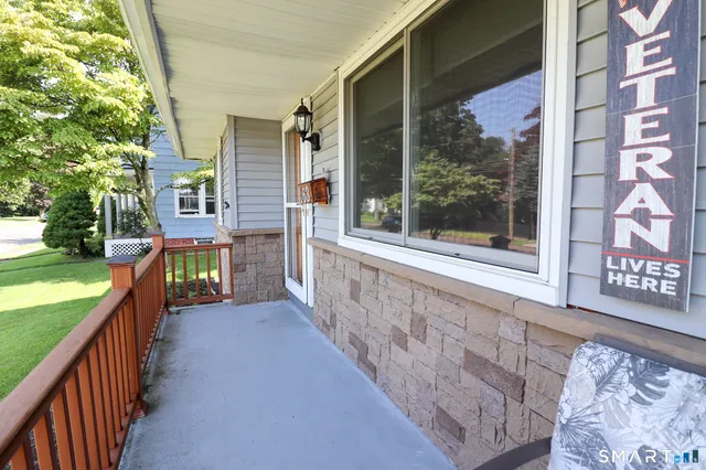 a view of backyard with outdoor seating and trees