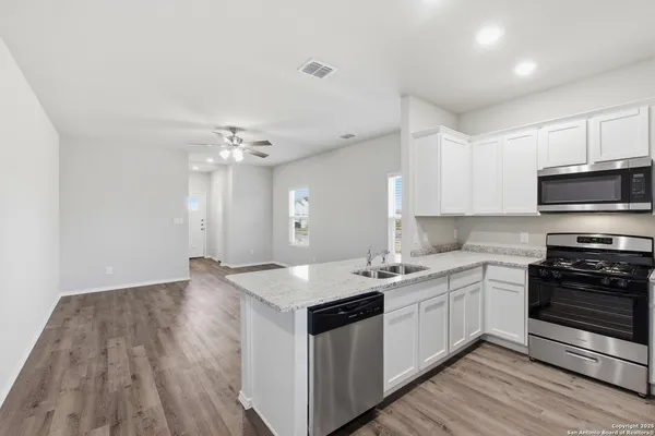 a kitchen with a sink cabinets and stainless steel appliances