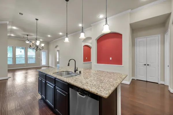 a kitchen with granite countertop cabinets a dining table and chairs