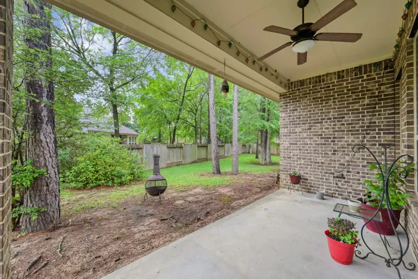 a view of a porch with furniture and a yard