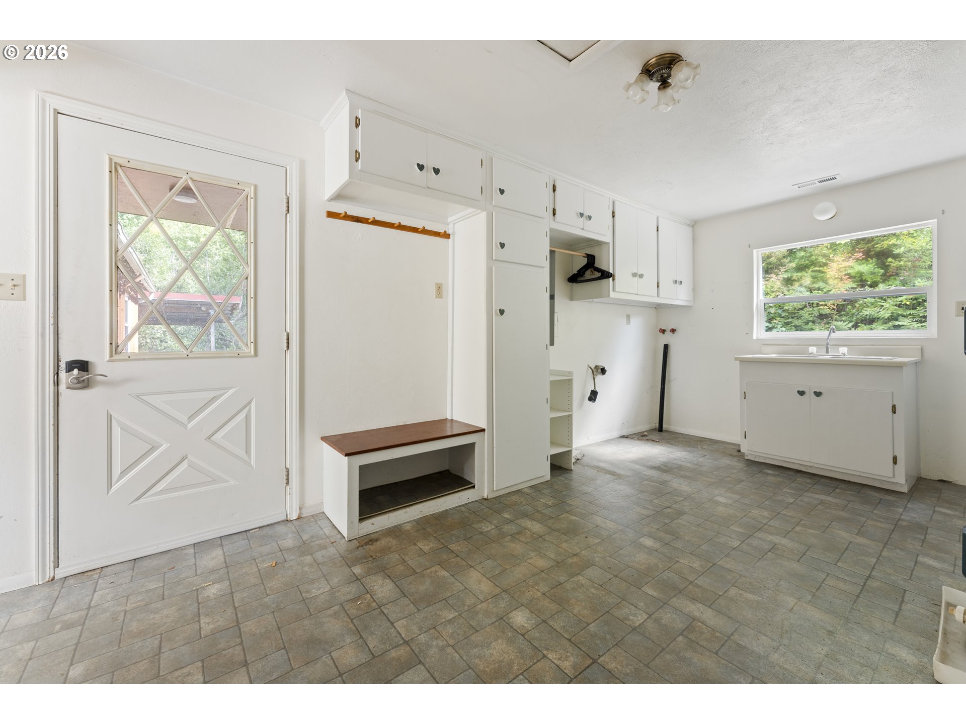 67085 Marlow Creek Road Coos Bay, OR 97420 - Photo 17 of 48 a view of kitchen with white cabinets and wooden floor