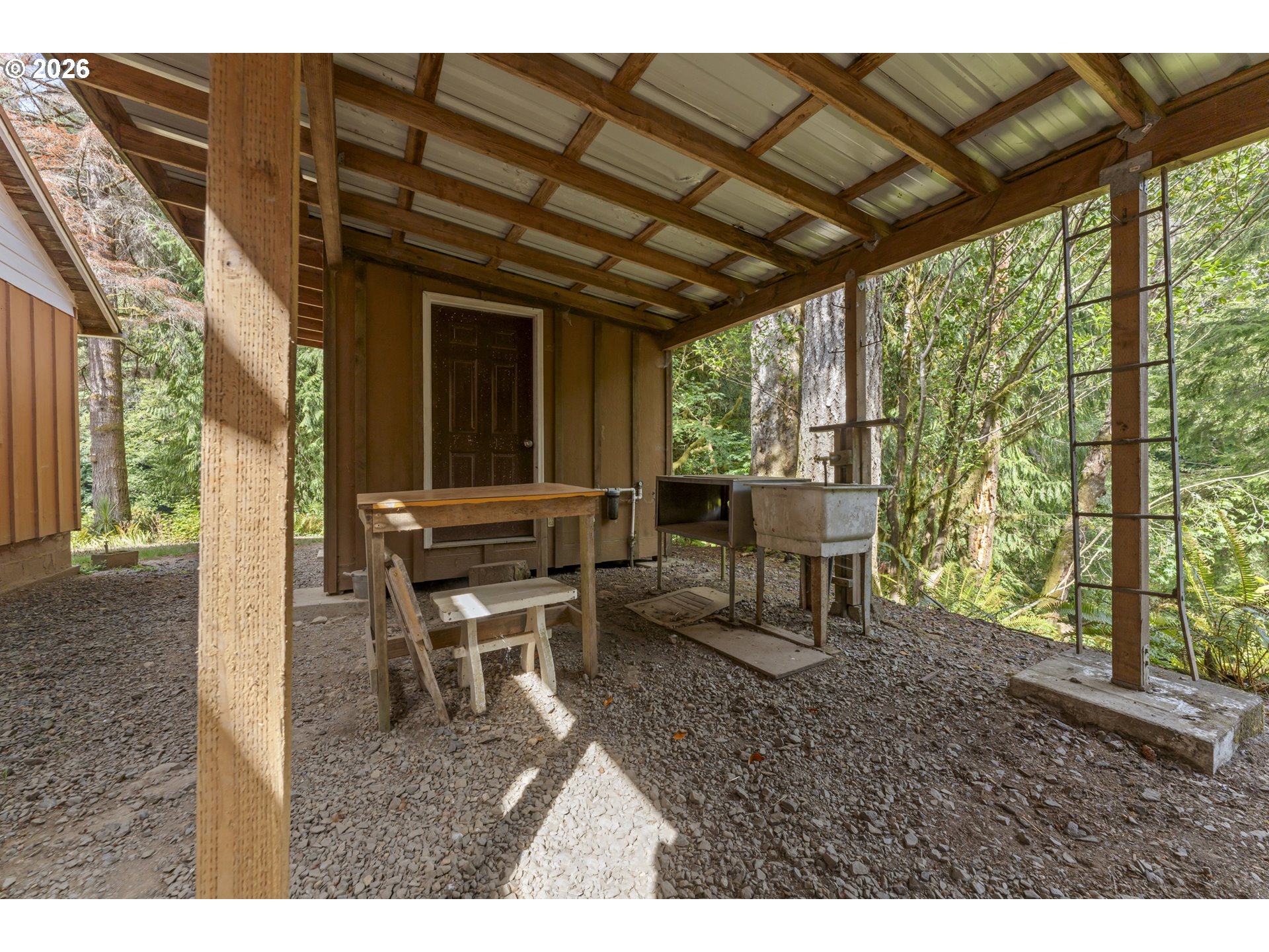 67085 Marlow Creek Road Coos Bay, OR 97420 - Photo 39 of 48 a view of a patio with table and chairs with wooden floor and fence