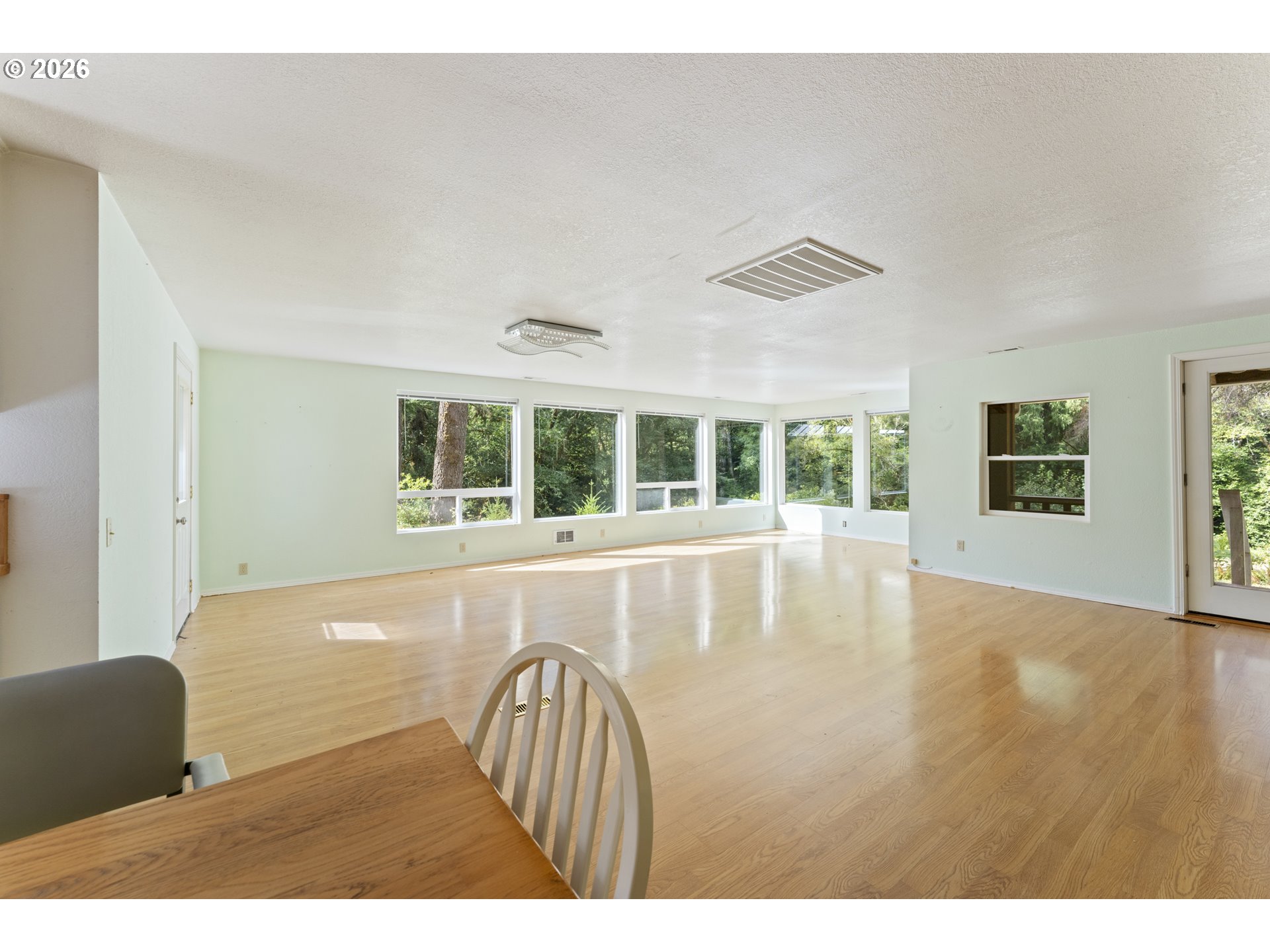 67085 Marlow Creek Road Coos Bay, OR 97420 - Photo 10 of 48 a view of an empty room with wooden floor and a window