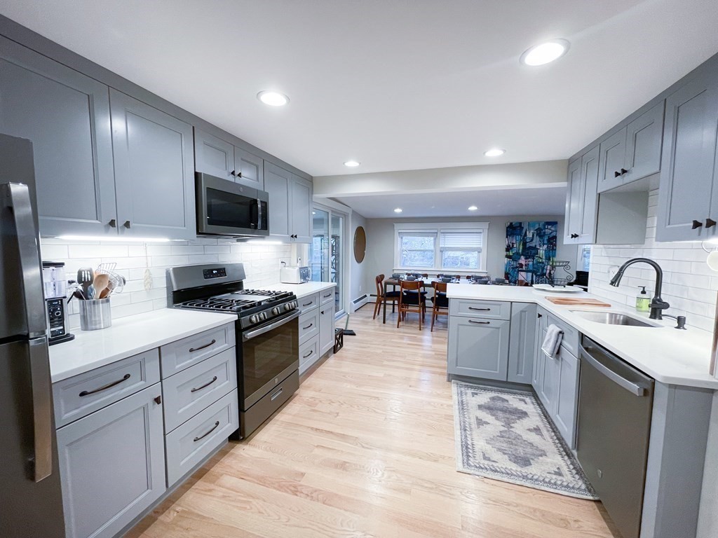 83 Rockridge Road Waltham, MA 02453 - Photo 4 of 16 a kitchen with stainless steel appliances granite countertop a sink and cabinets