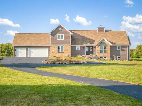 a front view of a house with swimming pool having outdoor seating