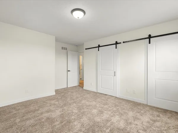 a view of an empty room with closet