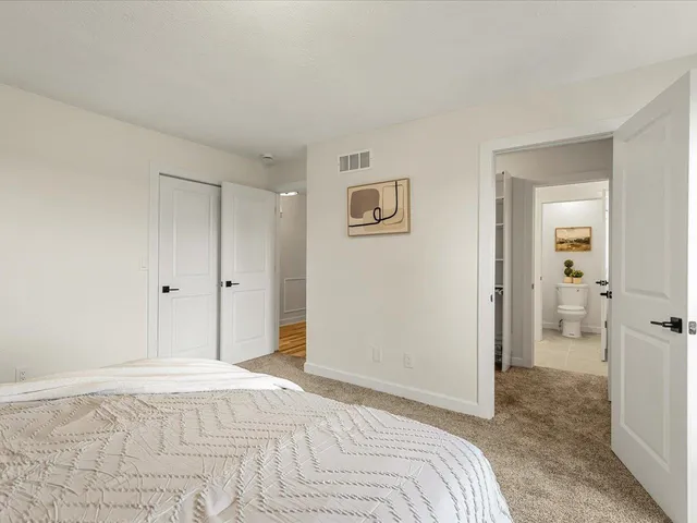 a bathroom with a granite countertop sink a toilet and shower