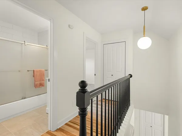 a view of an entryway with wooden floor and windows