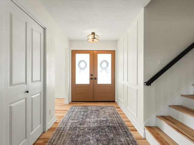 a view of a hallway view with wooden floor and staircase