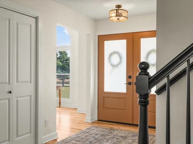 a view of an entryway with wooden floor and windows