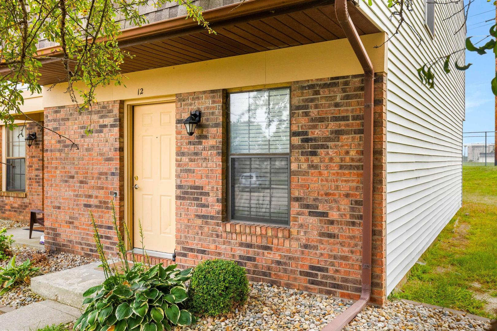a view of a brick house with a large window