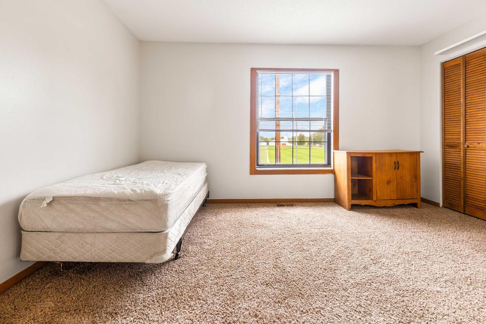 700 North Adelaide Street, Unit 12 Normal, IL 61761 - Photo 11 of 16 a room with a bed and a window