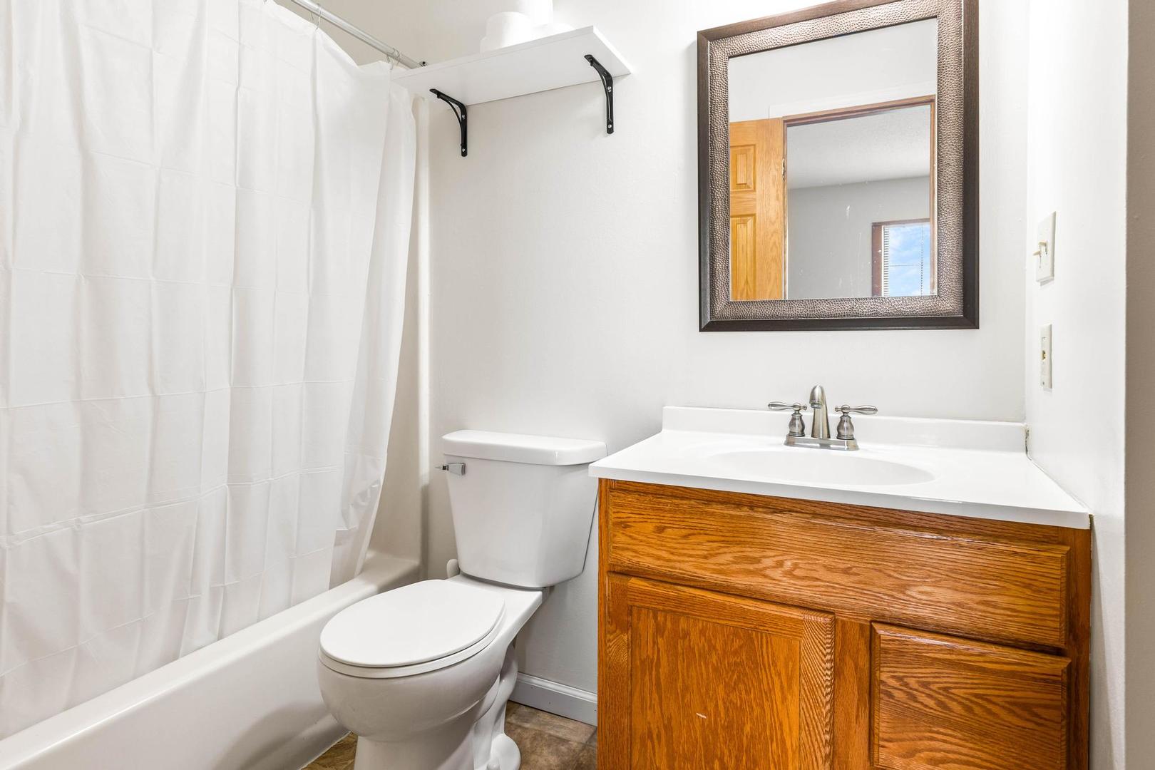 700 North Adelaide Street, Unit 12 Normal, IL 61761 - Photo 13 of 16 a bathroom with a granite countertop sink toilet and mirror