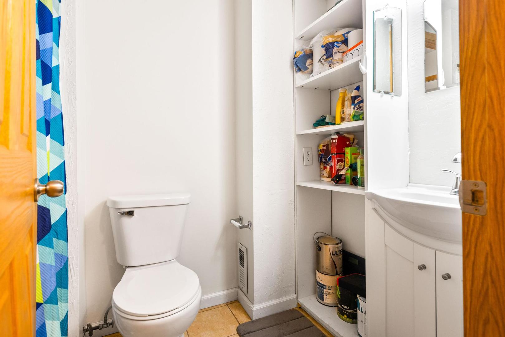 700 North Adelaide Street, Unit 12 Normal, IL 61761 - Photo 14 of 16 a white toilet sitting next to a bathroom sink and vanity