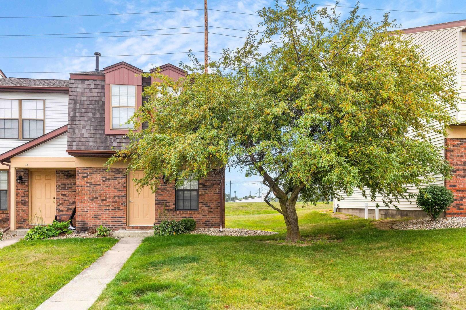 700 North Adelaide Street, Unit 12 Normal, IL 61761 - Photo 16 of 16 a large tree in the garden in front of a house