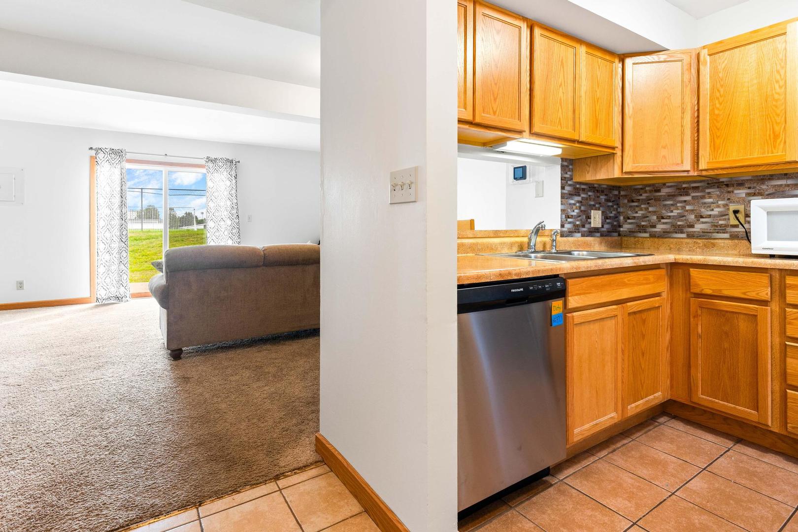 700 North Adelaide Street, Unit 12 Normal, IL 61761 - Photo 3 of 16 a kitchen with stainless steel appliances granite countertop a sink and a refrigerator