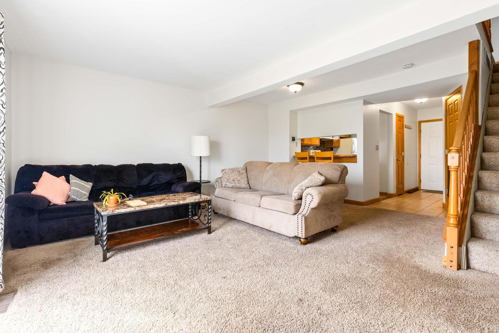 700 North Adelaide Street, Unit 12 Normal, IL 61761 - Photo 6 of 16 a living room with furniture and a couch