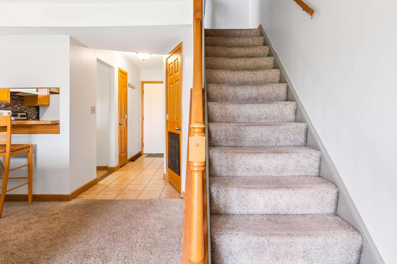 700 North Adelaide Street, Unit 12 Normal, IL 61761 - Photo 7 of 16 a view of staircase with white walls and a window