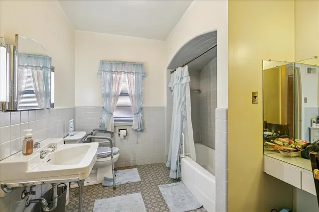 a bathroom with a toilet sink and mirror