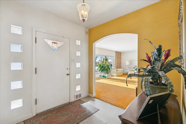 a bedroom with furniture and a large window