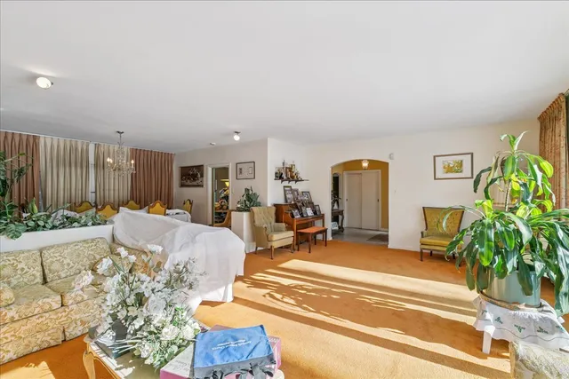 a view of a dining room with furniture and chandelier