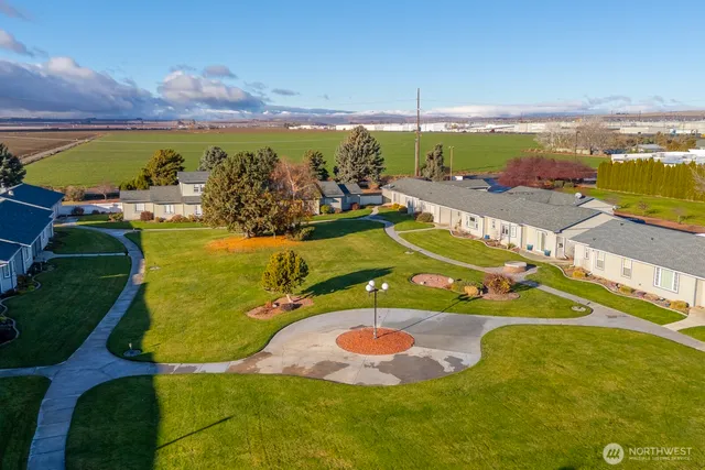 an aerial view of a pool with a yard
