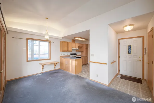 a view of a kitchen with refrigerator and wooden floor