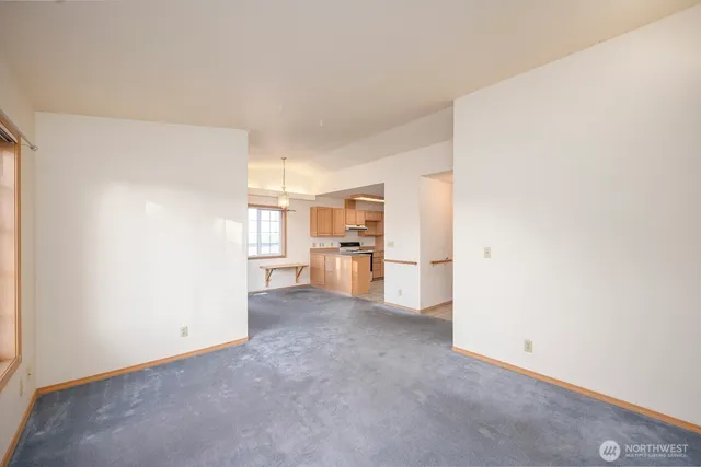 a view of a kitchen with furniture and an empty room