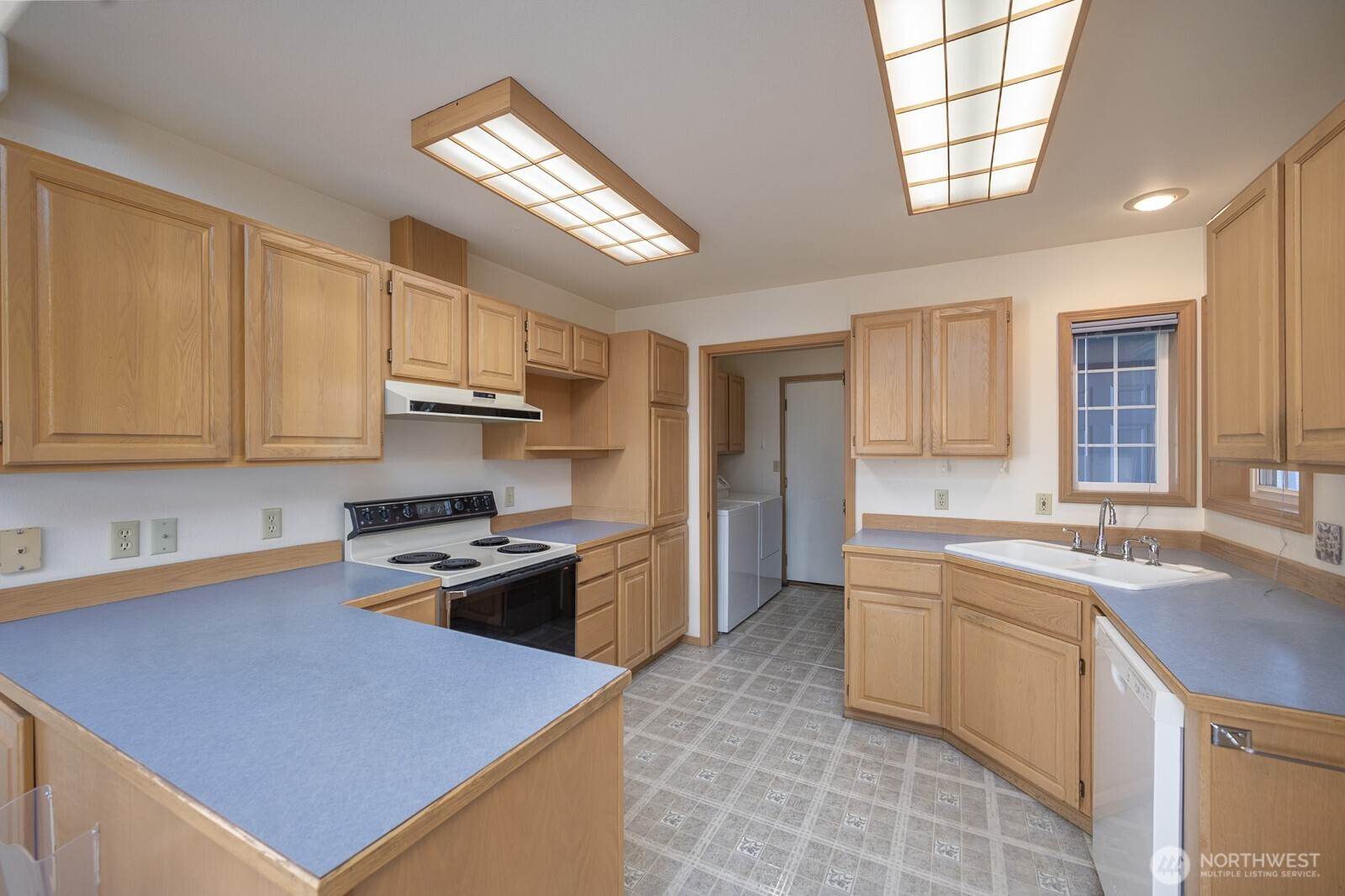 1000 13th Avenue Southwest, Unit 3 Quincy, WA 98848 - Photo 24 of 38 a kitchen with stainless steel appliances granite countertop a sink stove and refrigerator