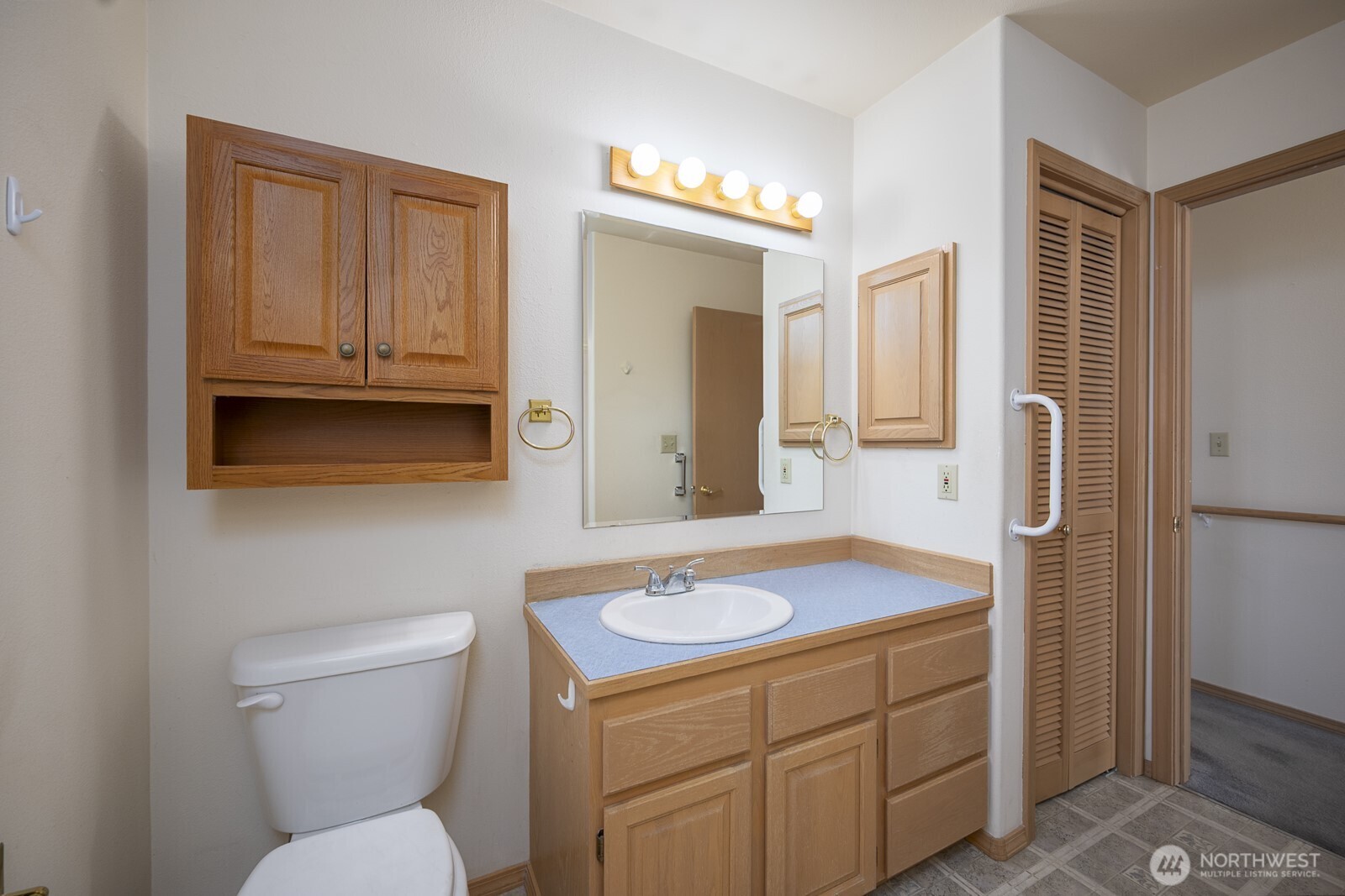 1000 13th Avenue Southwest, Unit 3 Quincy, WA 98848 - Photo 30 of 38 a bathroom with a sink a toilet a mirror and vanity