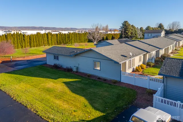 a view of a house with pool and chairs