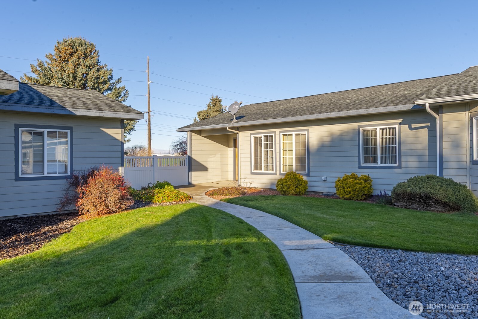 1000 13th Avenue Southwest, Unit 3 Quincy, WA 98848 - Photo 38 of 38 a front view of a house with garden and two chairs