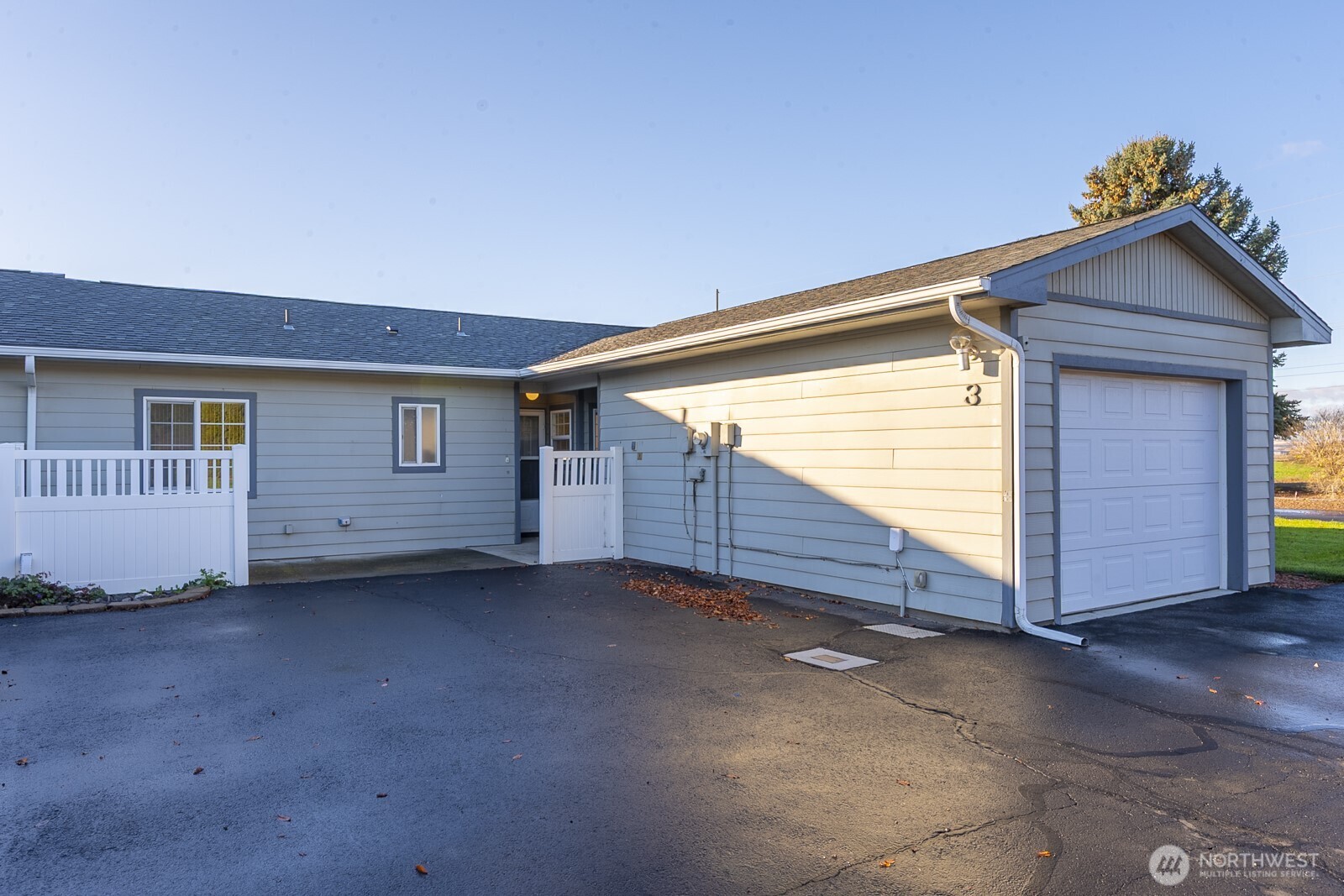 1000 13th Avenue Southwest, Unit 3 Quincy, WA 98848 - Photo 4 of 38 a view of a house with a small yard and wooden fence