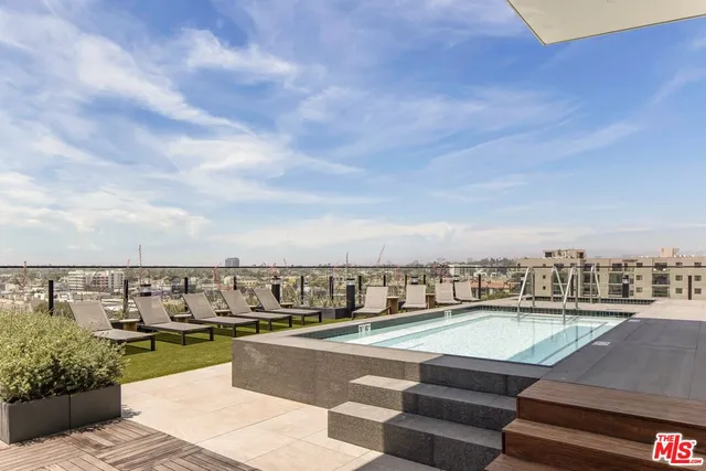 a view of swimming pool with outdoor seating