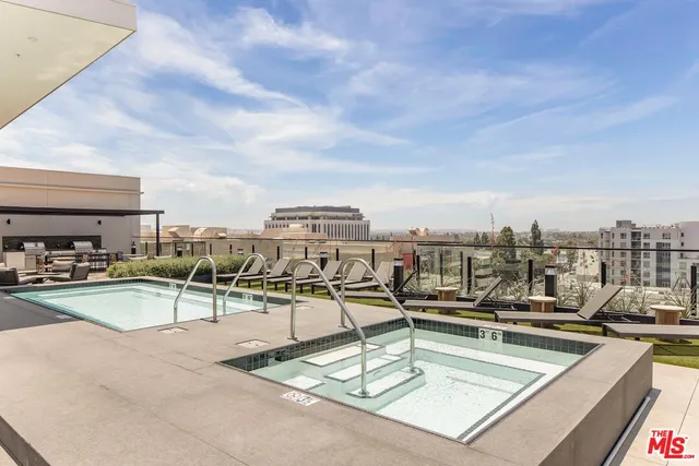a view of a swimming pool with outdoor seating