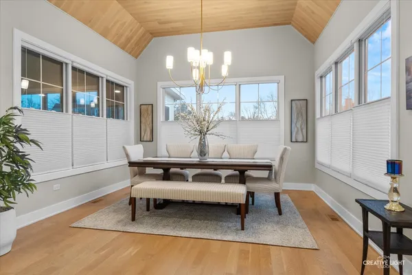 a view of a dining room with furniture and chandelier