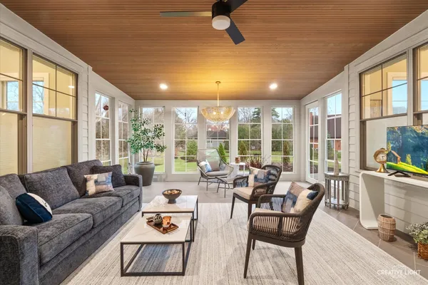 a living room with furniture and large windows