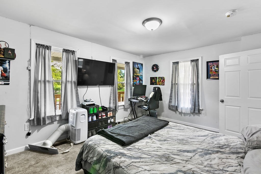 76 Marble Street Springfield, MA 01105 - Photo 10 of 27 a bedroom with bed tv and a large window