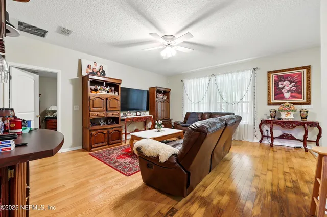 a living room with furniture a fireplace and a large window