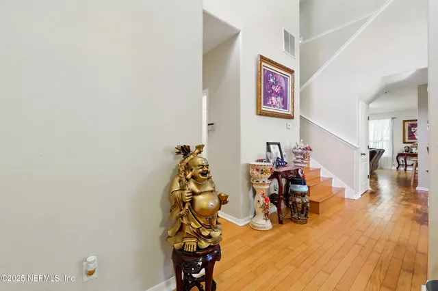 a view of a room with furniture and wooden floor