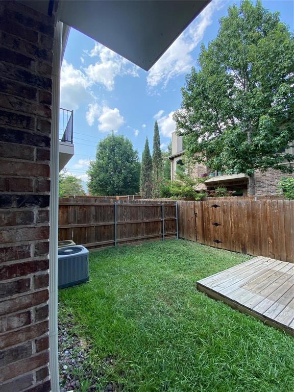 2222 Kirby Street Dallas, TX 75204 - Photo 2 of 25 Private fenced backyard featuring a wooden deck and mature trees