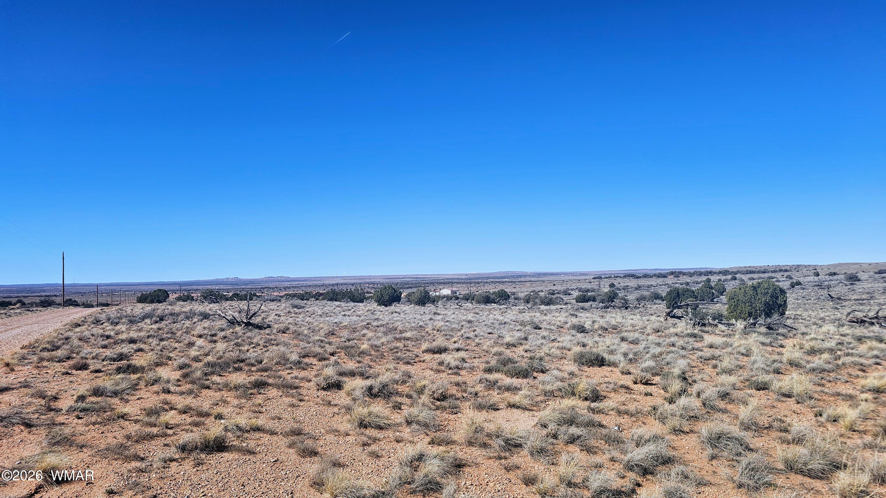 8334 Rockin R Ranch Trail Snowflake, AZ 85937 - Photo 6 of 28 a view of a dry yard with a wooden fence