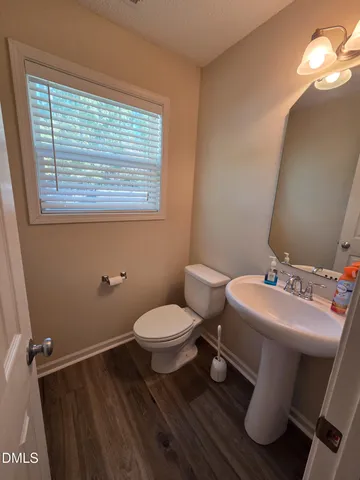 a bathroom with a sink toilet and window