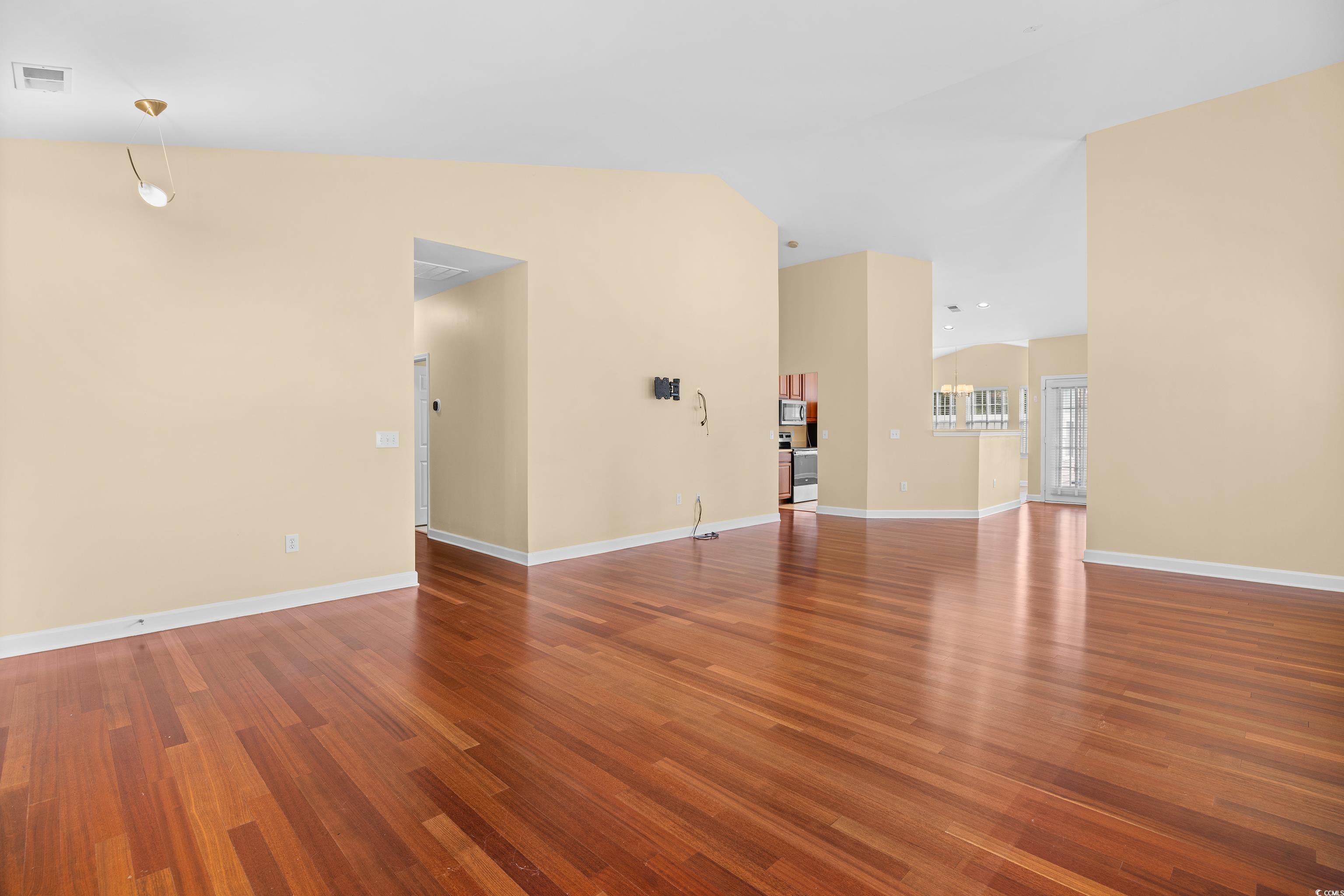 12-2 Rapture Court, Unit 2 Pawleys Island, SC 29585 - Photo 9 of 40 Empty room featuring wood finished floors and base