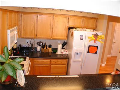 620 Ryan Lane Santa Rosa, CA 95407 - Photo 3 of 9 Kitchen features new corian counters, newer appliances, oak cabinets, and red oak floors.