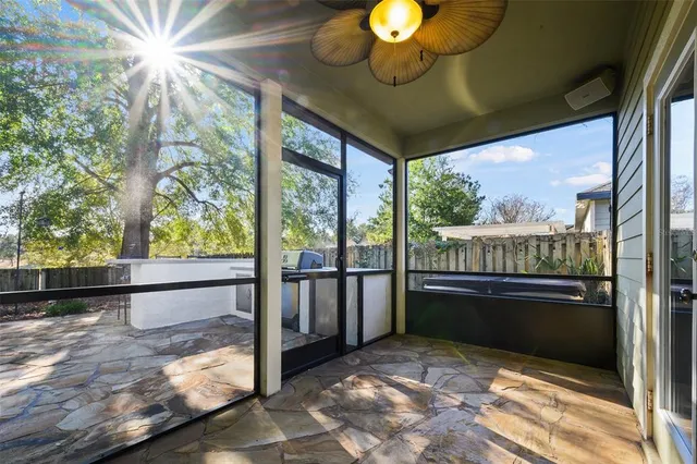 a view of a porch with a table and chairs