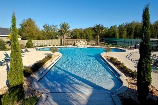 a view of a backyard with swimming pool
