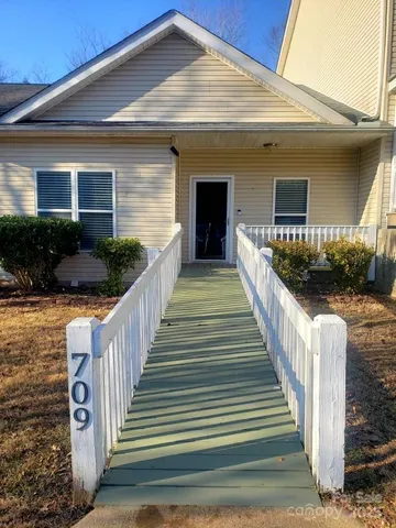 a view of a house with wooden fence