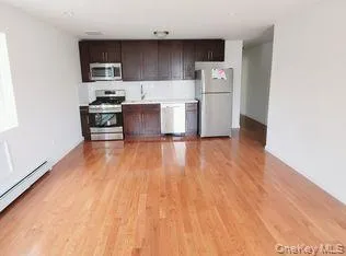 a kitchen with a refrigerator and a stove top oven