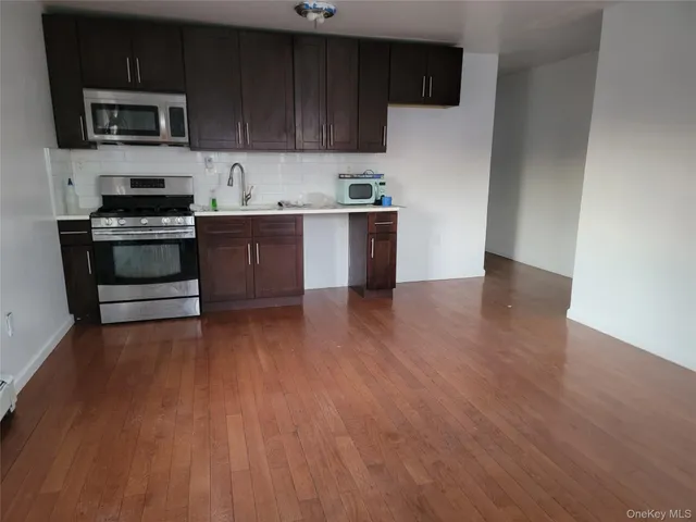 a kitchen with stainless steel appliances a refrigerator and a stove top oven